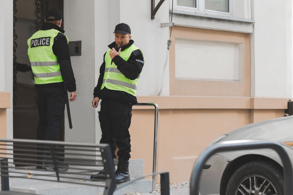 Two police officers outside of a building